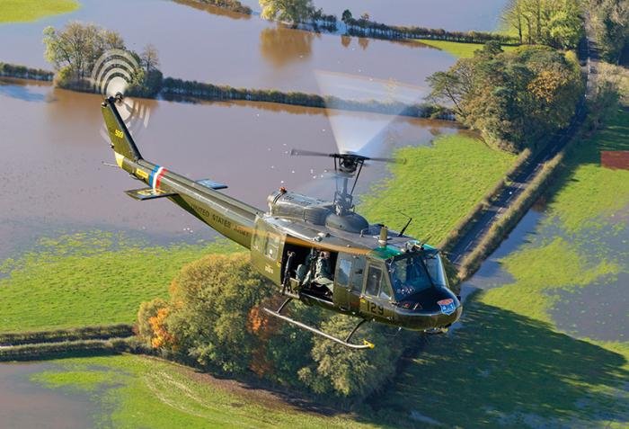 Huey 509 / Miss Jo takes flight. The flooded backdrop looking more like Vietnam in places than Lancashire.