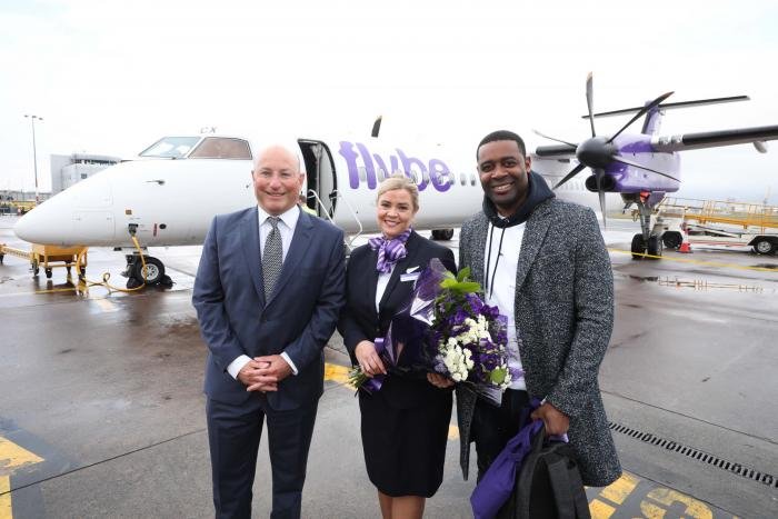 A first in Ireland: George Best Belfast City Airport's chief executive, Matthew Hall, and a member of the cabin crew welcome the first passenger, Andre Squire, to Belfast