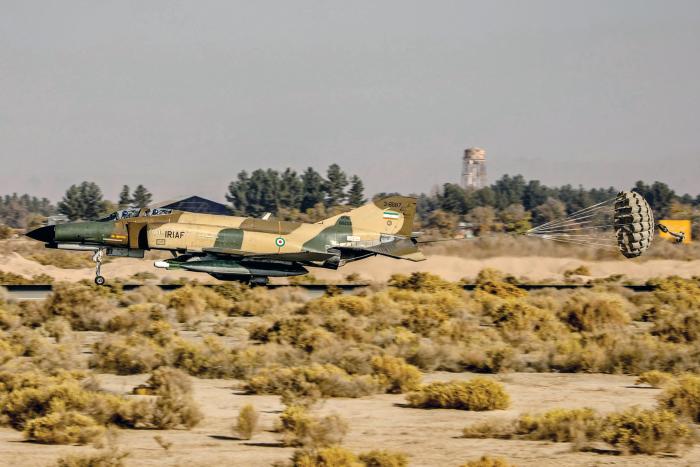 The braking parachute billows behind an IRIAF F-4E Phantom on the landing roll