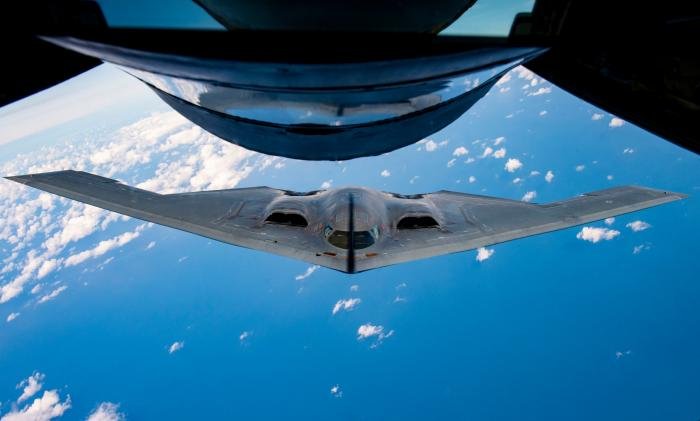The shadow from the boom of a KC-135 Stratotanker splits down the middle of the nose of a B-2 Spirit Stealth Bomber during a training mission for Bomber Task Force Europe over England, Sept. 16, 2019