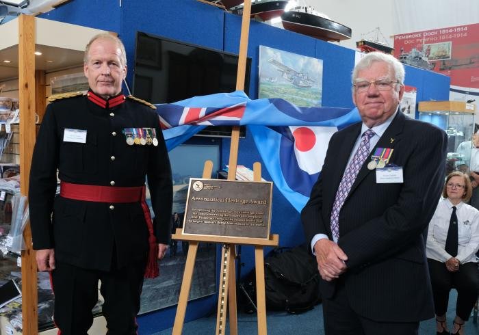 Deputy Lord Lieutenant Col Martin Green and Gp Capt Mike Hawkins,with the RAeS Heritage Award at the Pembroke Dock Heritage Centre.