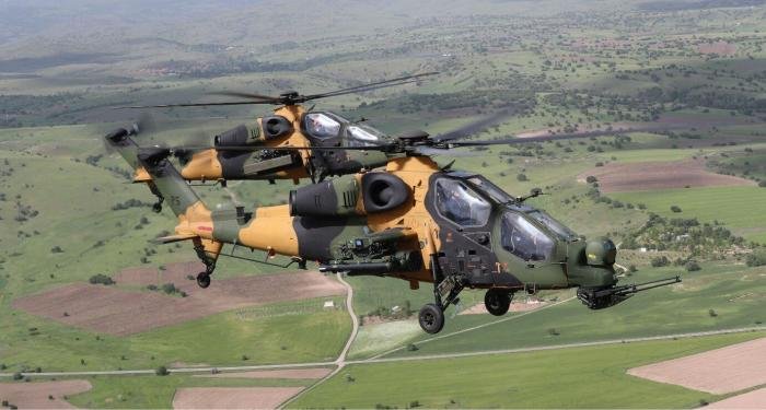 A pair of TUSAŞ-developed T129 ATAK helicopter gunships in flight.
