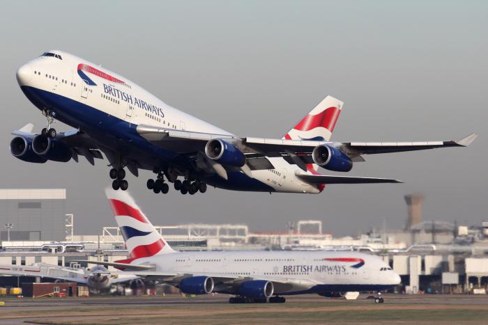 A British Airways Boeing 747-400 seen taking off from London/Heathrow in 2016 with an Airbus A380 in the background.