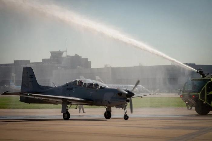 The first modernised Embraer EMB-312 Tucano for the FAA (serial A-122) is greeted with a traditional water cannon salute while it taxis in after arriving at the Aeroparque Military Air Station in Buenos Aires on August 5, 2022.