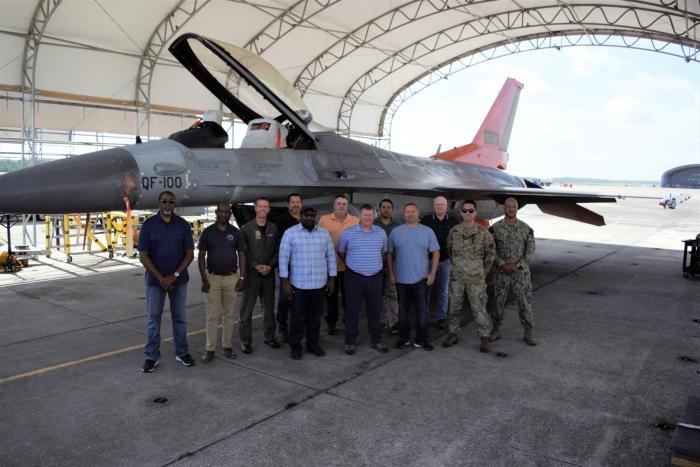 Personnel from the US DCMA's AIMO St Augustine pose in front of the last QF-16 'Zombie Viper' to be delivered from Boeing's modification line at Cecil Airport in Jacksonville, Florida, on July 29, 2022.