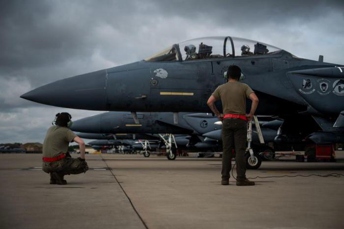 Crew chiefs from the 48th Aircraft Maintenance Squadron finish pre-flight checks of an F-15E Strike Eagle during Point Blank 22-4 at Royal Air Force Lakenheath, England, Aug. 25, 2022. The 48th Fighter Wing regularly takes part in this multilateral exercise as a way to strengthen interoperability with allied nations, and develop skills critical to gaining and maintaining air superiority. (