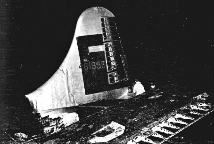 The near 28ft tail of ‘Over Exposed’ reaches into the night sky from the carnage of the wreckage – almost like a ready-made memorial – just hours after the aircraft was located. Note that the rudder and ailerons are exposed, a result of the post-crash fire. The tail was later destroyed as part of the salvage operation