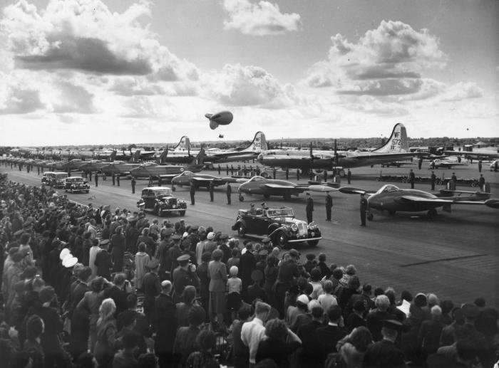 15th July 1953: Queen Elizabeth II at the Coronation Review of the RAF at Odiham Hampshire. She inspected 1125 officers and other ranks drawn from all commands of the RAF and over 300 aircraft with crew and personnel. Vehicles and equipment representing all branches of the services were also paraded and the visit ended with a fly past of more than 600 aircraft in review order. Visible aircraft include de Havilland Venom jet fighters (front row, right), B-29 Superfortress long range bombers (middle row), called Boeing Washingtons by the RAF, and American-built F-86 Sabre jet fighter (front row, middle).