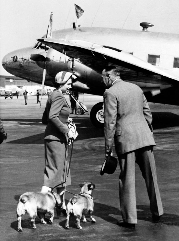 This photo was taken on May 10, 1953 and it shows Queen Elizabeth II with her Corgis dogs prior to boarding her aircraft at the London airport.