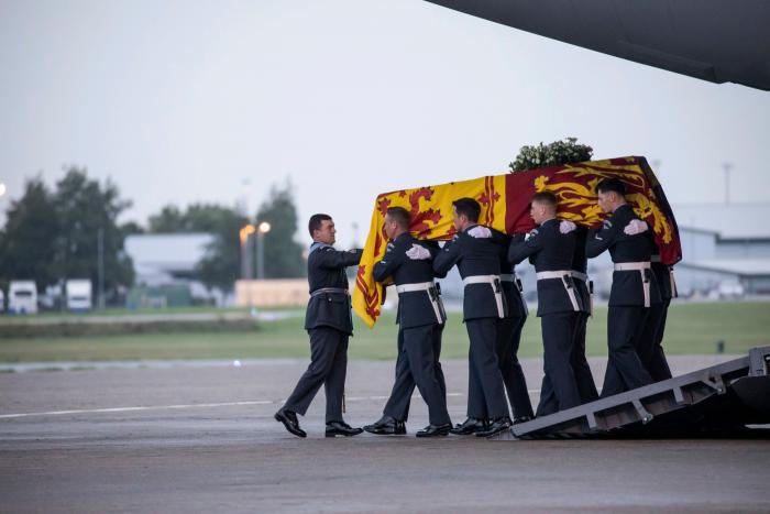 Pallbearers from the Royal Air Force Regiment carry the coffin of Her Majesty Queen Elizabeth II off the C-17 at RAF Northolt.