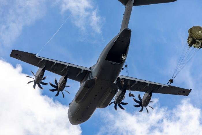 An RAF-operated Airbus A400M Atlas C1 (serial ZM414) conducts a low-level parachute drop trial over the Salisbury Plain in central-southern England on August 23, 2022. The A400M will succeed the Lockheed Martin C-130J Hercules C4/C5 in the tactical airlift role in 2023.