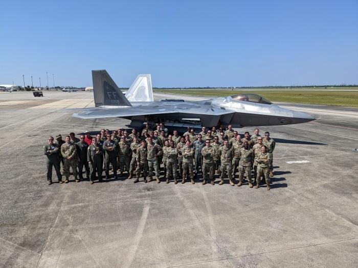Personnel from the 94th FS and the 94th FGS pose for a photo in front of an F-22A Raptor at Tyndall AFB, Florida, after breaking the record for the most air-to-air missiles loaded and successfully fired by an F-22 Raptor in USAF service.