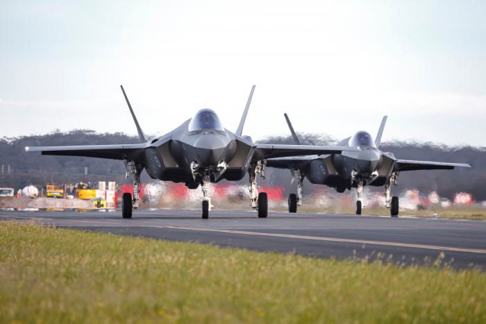 Two of Australia's four latest F-35A Lightning IIs (serials A35-053 and A35-054) taxi in after landing at RAAF Base Williamtown, New South Wales, following their delivery flight from Luke AFB, Arizona, during Exercise Lightning Ferry 22-3.