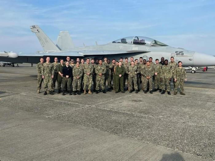 Personnel involved in the refurbishment of EA-18G Growler (BuNo 157015 'NE-515') pose for a photo with the aircraft at NAS Whidbey Island on October 28, 2022. The Growler will be transferred to a frontline squadron in the near future.