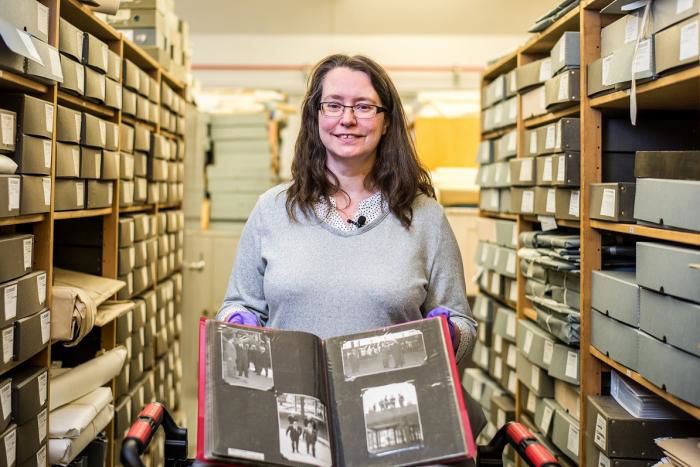 Nina Hadaway, Archive, Library and Research Manager, with the photograph album of RAF Hendon