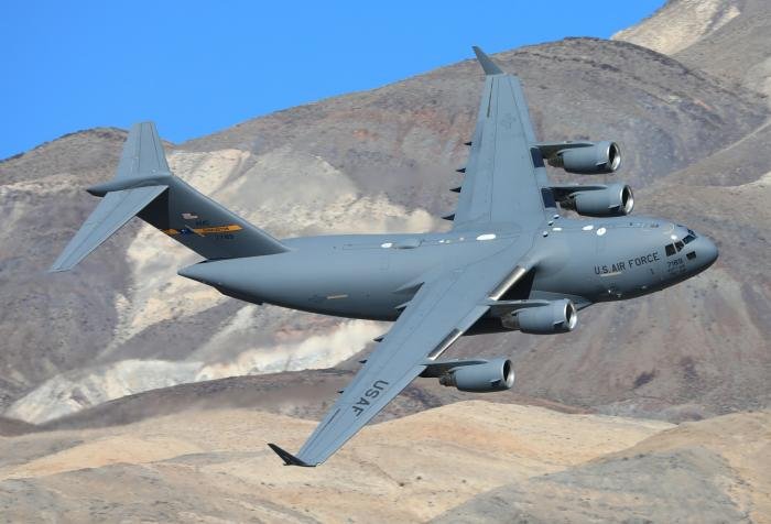 This shot was taken on a hilltop in a wash near Panamint California, when this Charleston AFB C17 went low level through the famous sidewinder route.