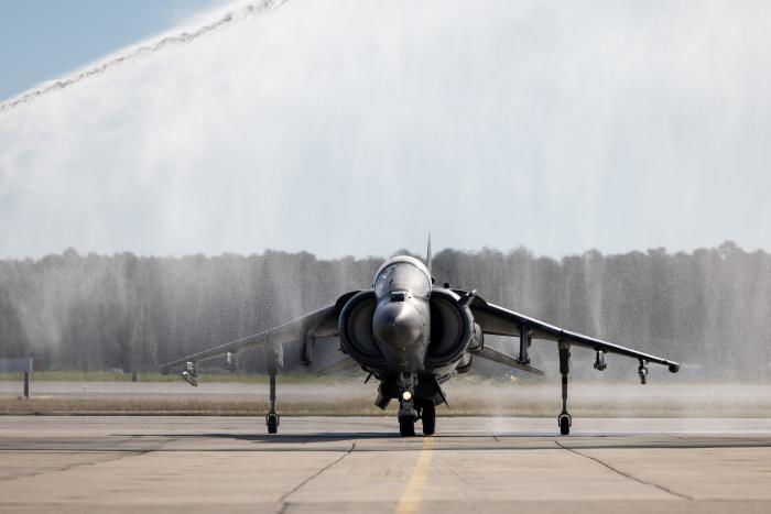 A USMC-operated AV-8B Harrier II assigned to VMA-542 'Flying Tigers' at MCAS Cherry Point in North Carolina receives a traditional water cannon salute during the transition and redesignation ceremony on December 1, 2022.