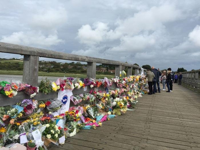 Floral tributes to those who died on Shoreham Tollbridge close to the crash site