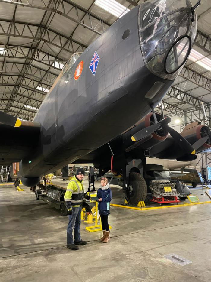 Imogen Smith hands Sgt Crisp’s logbook to Yorkshire Air Museum’s Graham Buckle