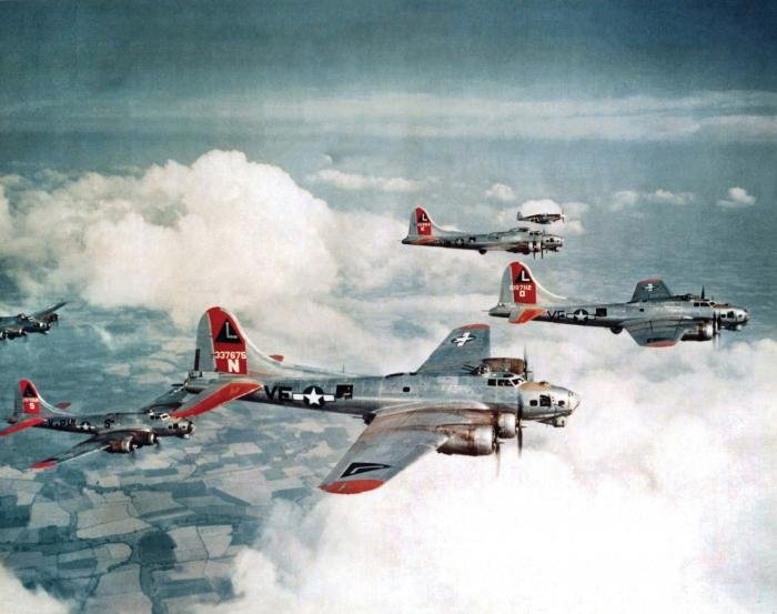 A famous colour image of 381st Bomb Group B-17Gs being escorted on a training sortie by a 355th Fighter Group P-51.