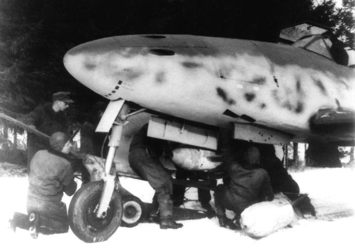 Bombs being mounted beneath the forward fuselage of an A-2 model belonging to KG 51.