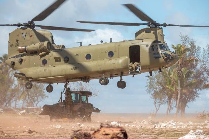 An AAAC-operated CH-47F Chinook (serial A15-307) prepares to airlift plant equipment from Atata Island, Tonga, after completing a clean-up mission as part of Operation Tonga Assist 2022.
