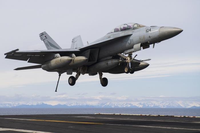 An F/A-18F Super Hornet assigned to the US Navy's Strike Fighter Squadron 154 (VFA-154) 'Black Knights' prepares to land aboard the aircraft carrier, USS Theodore Roosevelt (CVN-71), after carrying out a mission over Alaska on May 7, 2021.