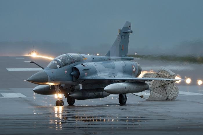 Indian Air Force Mirage 2000TI leaves the active with its drag chute still attached as another Mirage touches down