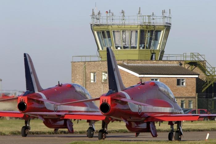 Hawk T1s of the RAF Red Arrows taxiing past the Scampton control tower during the team's time at the Lincolnshire base.