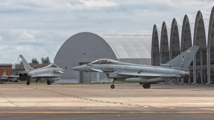 A pair of 12 Squadron Eurofighter Typhoon FGR4s taxiing from their sun sheds at RAF Coningsby