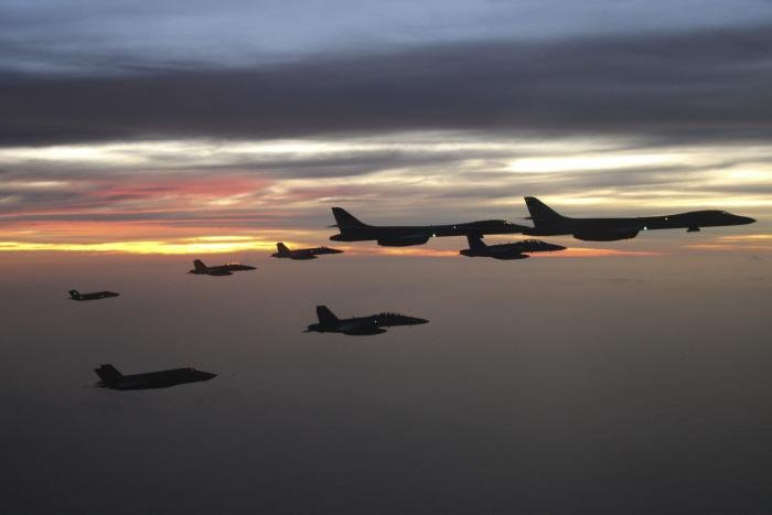 Two USAF-operated B-1B Lancers from the 34th EBS fly in formation with US Navy combat aircraft assigned to the aircraft carrier, USS Nimitz (CVN-68) and USMC F-35B Lightning IIs from Marine Fighter Attack Squadron 122 (VMFA-122) 'Flying Leathernecks' during an all-domain joint exercise over the South China Sea on February 17, 2023. The US Navy aircraft comprise two single-seat F/A-18E Super Hornets from Strike Fighter Squadron 22 (VFA-22) 'Fighting Redcocks', a single dual-seat F/A-18F from VFA-94 'Mighty Shrikes' and an EA-18G Growler from Electronic Attack Squadron 139 (VAQ-139) 'Cougars'.