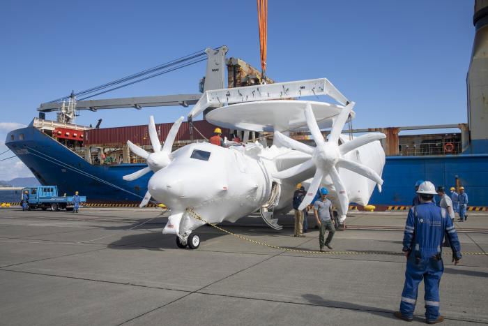 One of the two additional Northrop Grumman E-2D Advanced Hawkeyes delivered to the JASDF being unloaded from the General Cargo ship, Ocean Gladiator, at Iwakuni on October 18, 2022.