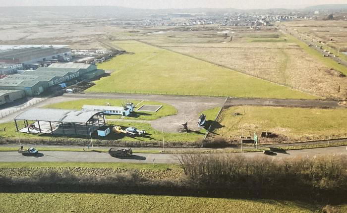 An elevated view of the museum site showing the expanded 500m landing strip, event area and new hangar under build, with the EH101 visible at lower centre