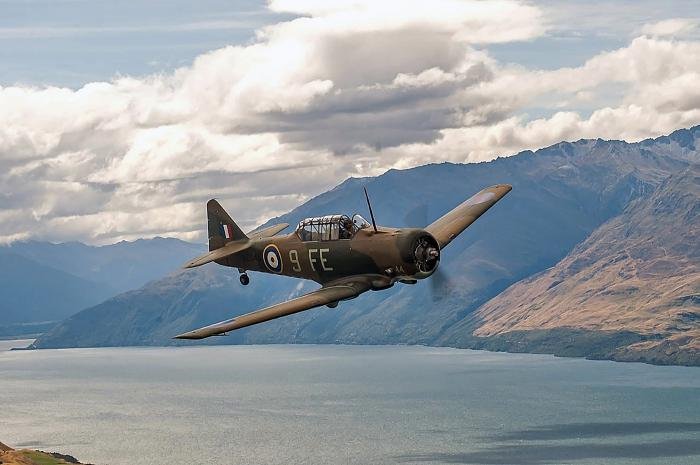 Bevan Dewes test-flying his Harvard IIa, NZ1044, over Lake Wanaka.