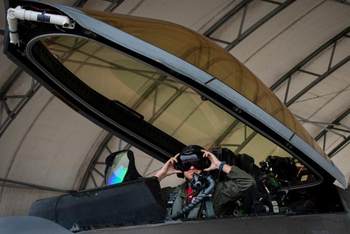 Maj Brett Gedman, an F-22A pilot from the 301st FS, adjusts his prototype NGFWH helmet before departing Eglin AFB for a mission on March 24, 2023.