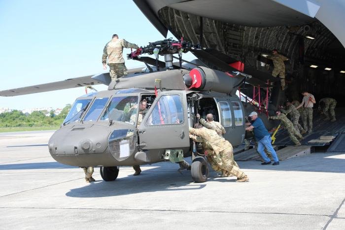 One of the first three UH-60V Black Hawks for the US Army's A/1-214th AVN 'Aces' is offloaded from a USAF-operated C-17A Globemaster III after arriving at Wiesbaden Army Airfield in central Germany on June 4, 2023.