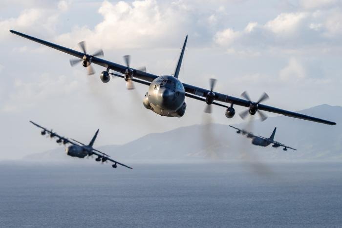 A C-130H(NZ) Hercules from the RNZAF's No 40 Squadron leads a pair of USAF MC-130J Commando IIs during a formation flight on May 23, 2022. Stationed at RNZAF Base Auckland in Whenuapai, just four of New Zealand's legacy Hercules transports remain operational, with the type due to be replaced by the C-130J in 2025.