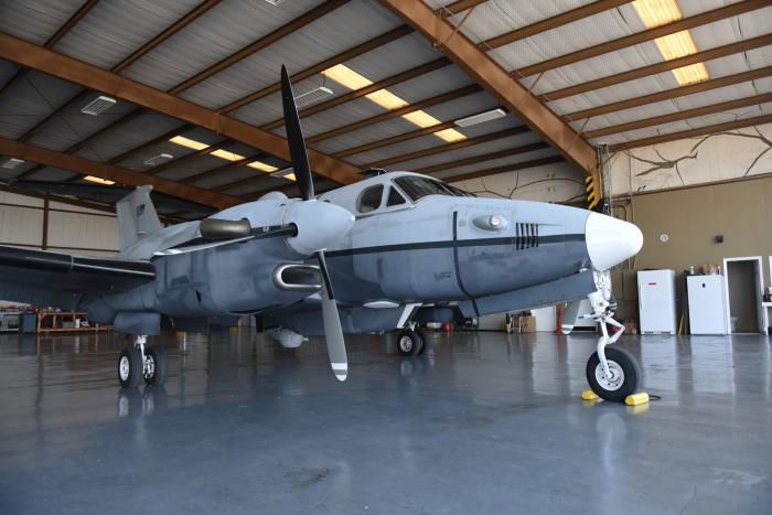 A USAF-operated MC-12W Liberty assigned to the Oklahoma ANG's 137th Special Operations Wing (SOW) rests in a hangar at San Angelo Regional Airport-Mathis Field, Texas, on August 24, 2022.