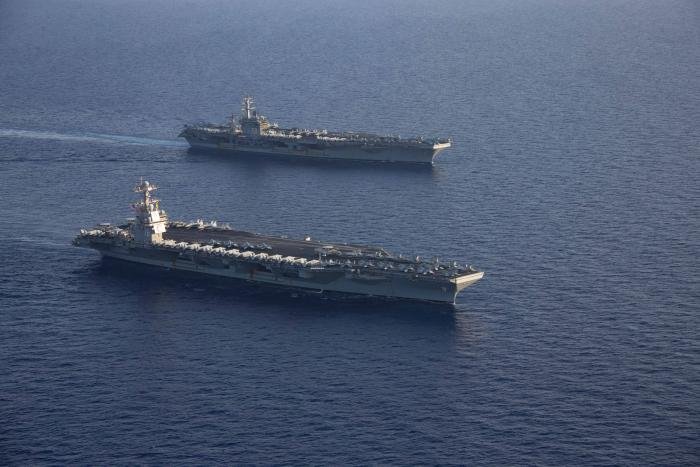 The USS Gerald R Ford (CVN-78), front, and USS Dwight D. Eisenhower (CVN-69), rear, transit the Mediterranean Sea on November 3. The two CSGs are operating in the area at the direction of the Secretary of Defense to bolster deterrence in the region.