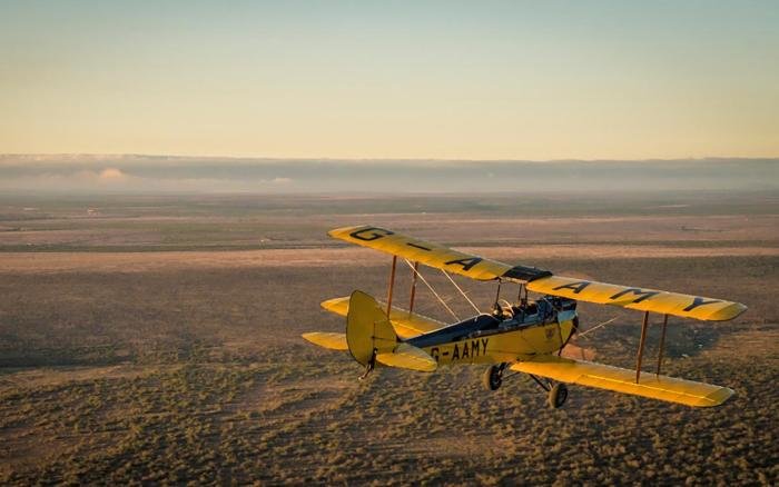Henry Labouchere flying DH60GMW 'Metal Moth' G-AAMY over the Kenyan countryside.