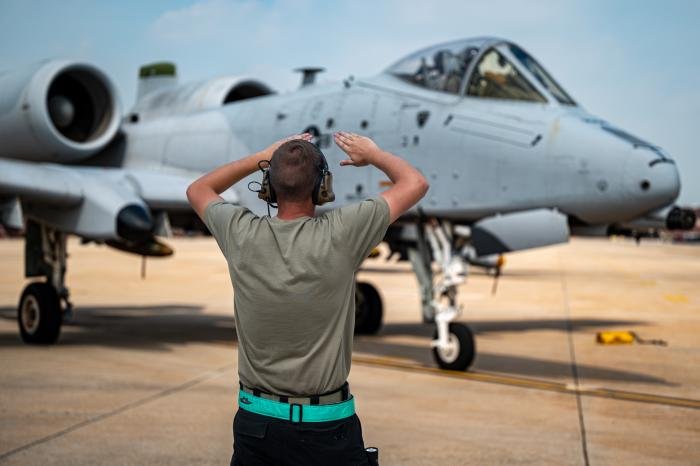 A 25th Fighter Generation Squadron crew chief directs an A-10C Thunderbolt II before take-off at Osan Air Base, Republic of Korea.