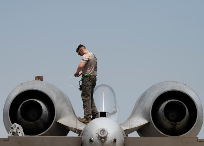 A maintainer assigned to the 25th Fighter Generation Squadron stands on an A-10C Thunderbolt II during Korea Flying Training 2023 at Gwangju Air Base.