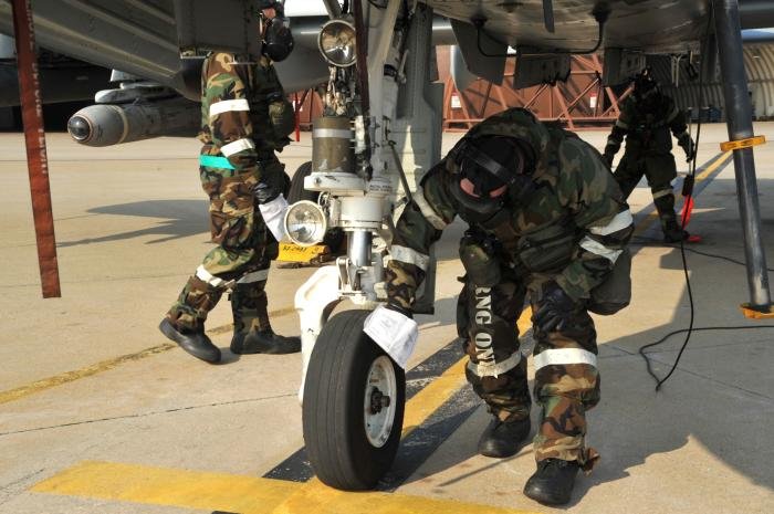 Airmen decontaminate an A-10 Thunderbolt II during a training scenario as part of Operational Readiness Exercise Beverly Midnight at Osan Air Base, Republic of Korea. If an aircraft is exposed to a chemical, biological, radiological, or nuclear contaminant in a real-world operation, the surface must be wiped down to create a clean path for the pilot to exit the plane.