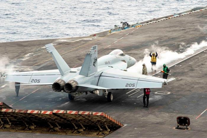 An F/A-18E Block III (169964/NE-205) assigned to CVW-2’s VFA-113 ‘Stingers’ prepares to launch from the flight deck of the Nimitz-class aircraft carrier, USS Carl Vinson (CVN-70), while performing routine operations in the Philippine Sea on December 4, 2023.